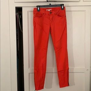 Bright red zippered skinny ankle jeans